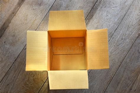 Top View Of Empty Open Cardboard Box On Wooden Background Stock Photo