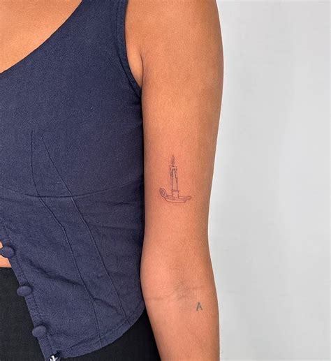 Fine Line Style Candle Tattoo Located On The Bicep