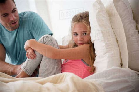 Father Talking To Daughter In Bedroom Stock Photo Dissolve