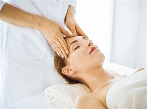 Beautiful Woman Enjoying Facial Massage With Closed Eyes In Spa Center Stock Image Image Of