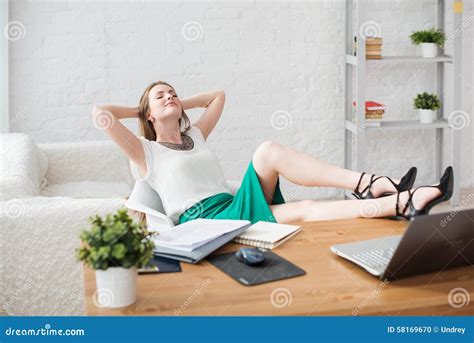 Man Is Relaxing With Legs On Table And Is Watching Football Match On Tv