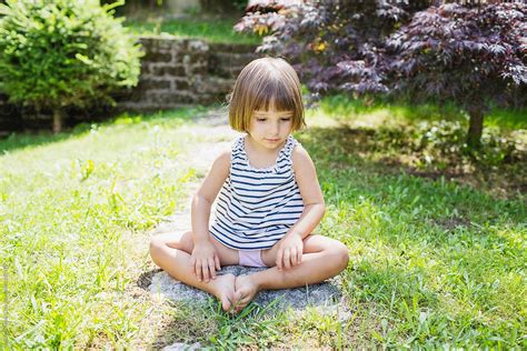 Little Girl Sitting In The Garden By Stocksy Contributor Michela