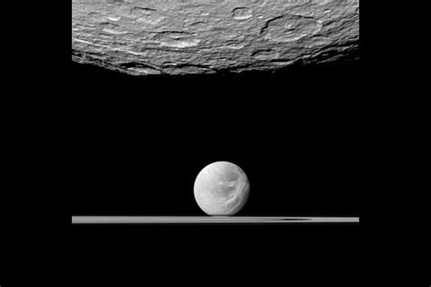 Nasacratered Southern Surface Of Saturns Moon Rhea Top Looms Over