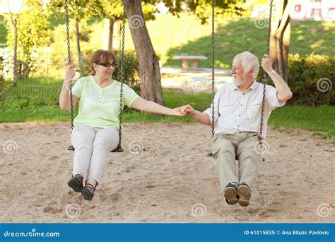 Senior Couple Swinging In The Park Stock Image Image Of Carefree Dating 61015835