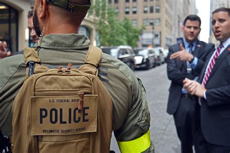 A Dss Mobile Security Deployments Team Member Left Confers With Other