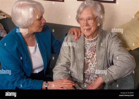 Elderly Woman Being Comforted By A Daughter Or Relative Stock Photo Alamy