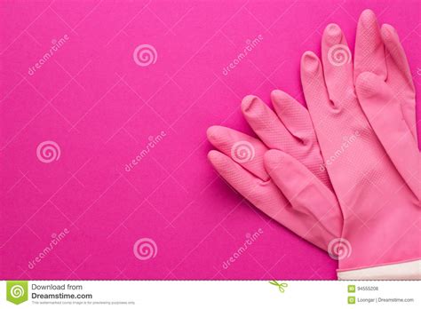 Pink Rubber Glove For Cleaning With The Palm Up And Next To The Construction Glove With The Palm