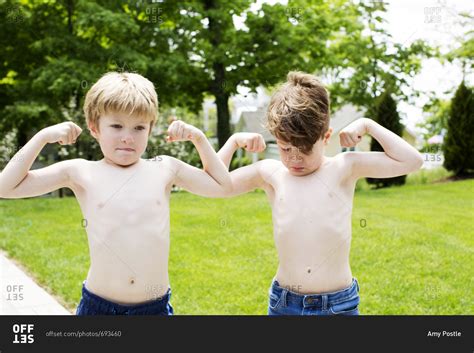 Two Kids Flexing Their Muscles Outside Stock Photo Offset