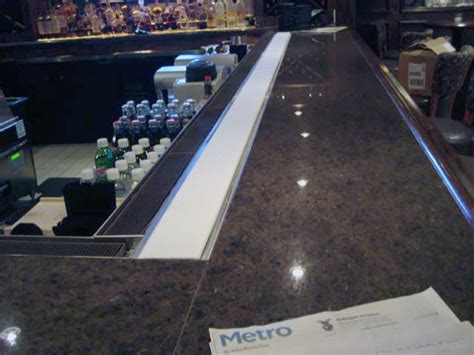 A Bar With A Built In Chilled Strip For Keeping Drinks Cold