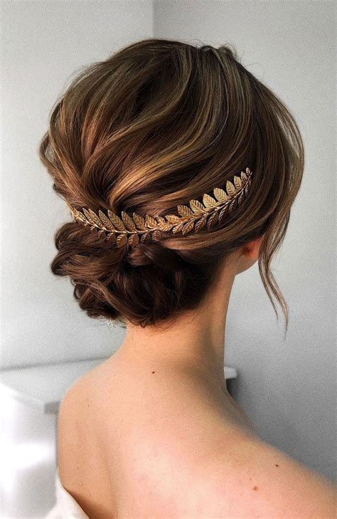 The hair is swept to the side in a pompadour fashion and the medium length locks hang to the side. 100 Prettiest Wedding Hairstyles For Ceremony & Reception