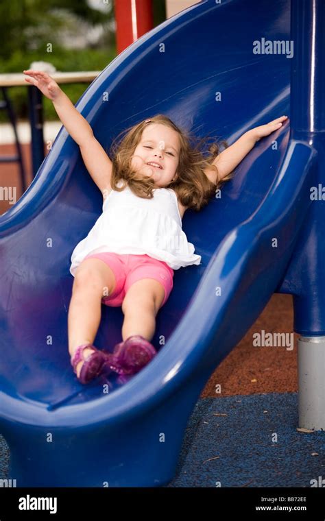Young Girl Sliding Down Slide At Playground Fort Lauderdale Florida