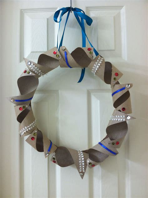 A Wreath Made Out Of Shoes Hanging On The Front Door With Blue Ribbon