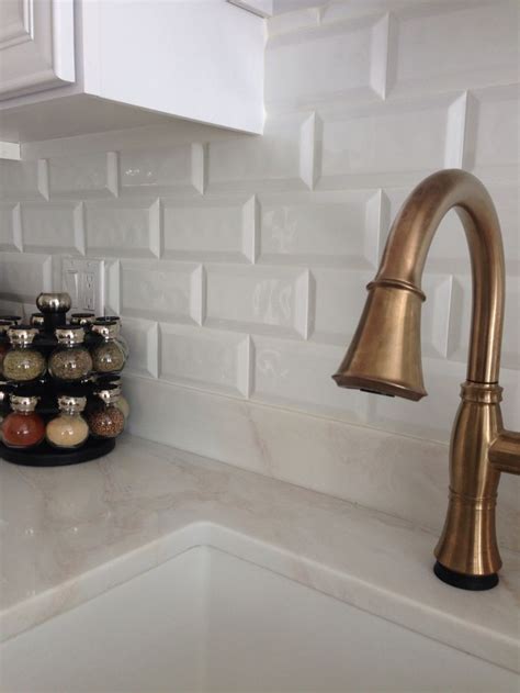 While a shiny brass or gold faucet might conjure up images of tacky 80s bathrooms, this brushed finish has a rich, sophisticated feel. Champagne bronze delta Cassidy faucet. Cobsa white bevel ...