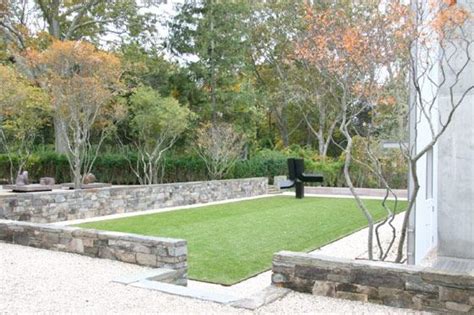 An Outdoor Area With Grass And Stone Walls