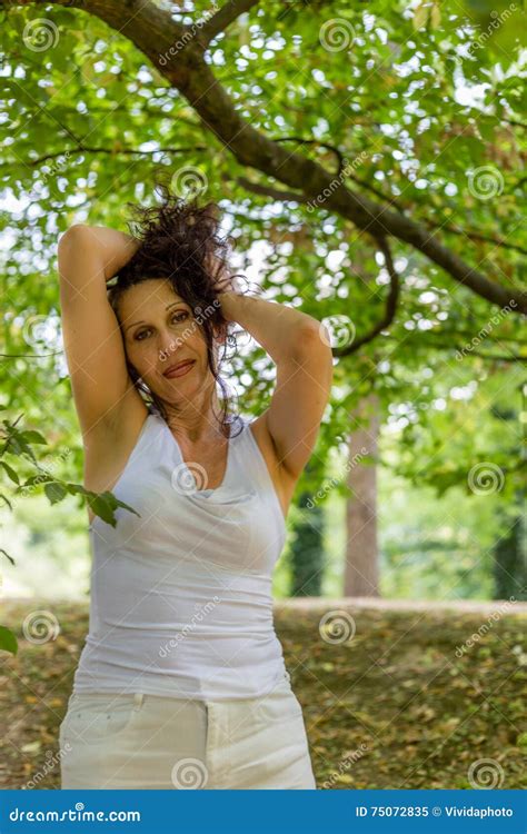 mature woman putting up her hair stock image image of leaning mature 75072835