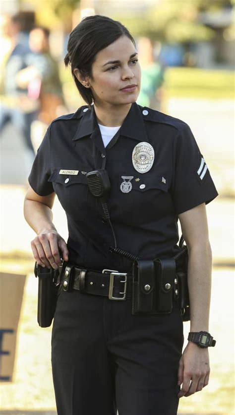 A Woman Police Officer Is Standing In The Street