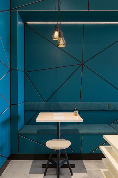 My blue accent wall painting idea for a bedroom. The interior of this cafe is covered in geometric panel ...