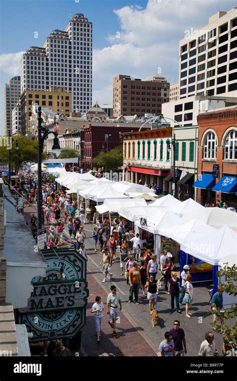 People Walk Down 6th Street During The Pecan Street Festival In Austin