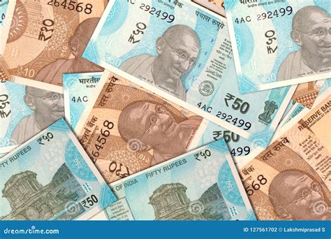 Scattered Indian New 10 And 50 Rupee Currency Notes Stock Photo