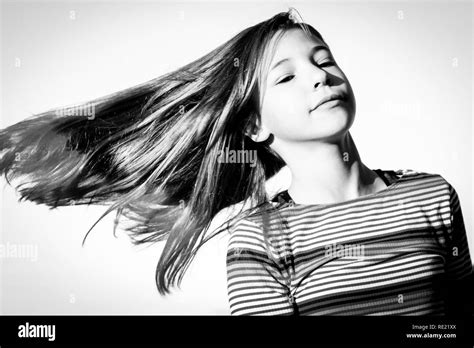 Tween Girl Is Isolated Against The Sky While Twirling And Swinging Her