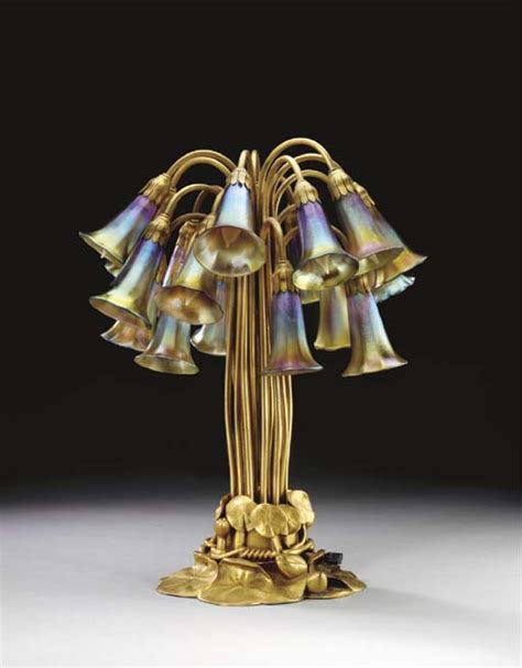 AN EIGHTEEN LIGHT LILY FAVRILE GLASS AND GILT BRONZE TABLE LAMP