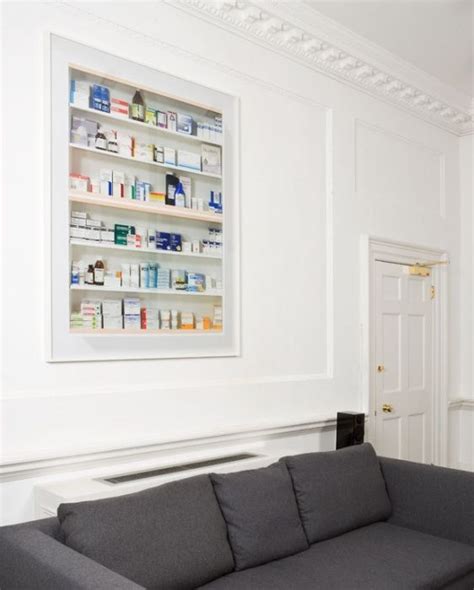 In hirst's pharmacy the small medicine cabinets of the earlier pieces have been expanded to cover the walls with rows of packaged drugs behind glass. Other Criteria - Godless - Damien Hirst (With images ...