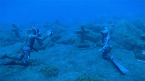 Divers Explore Eerie Underwater Cemetery Youtube