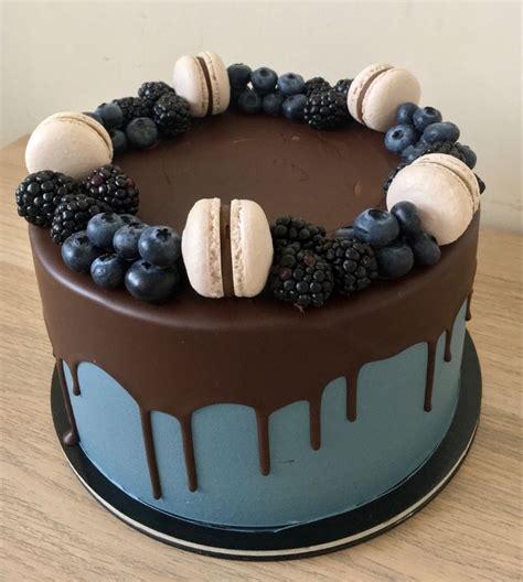 A Chocolate Cake Topped With Blueberries And Blackberries