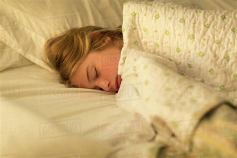 Caucasian Girls Sleeping In Bed Under Blanket Stock Photo Dissolve