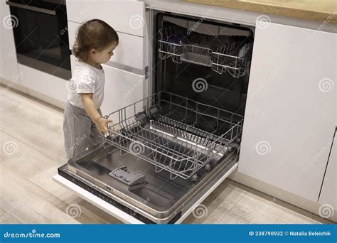 Little Cute Toddler Girl Helping To Open Unload Dishwasher Funny