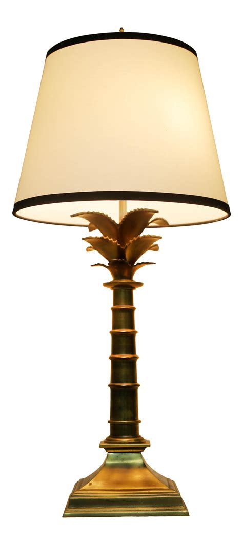 A Table Lamp With A White Shade On Its Base And A Black Trim Around