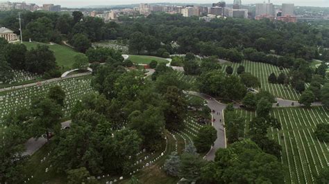 48k Stock Footage Aerial Video Flying By Rows Of Grave Stones At