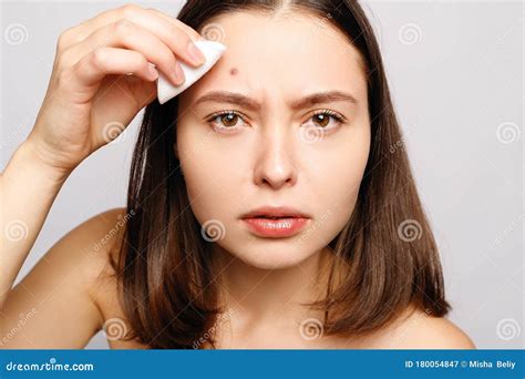 Portrait Of Young Attractive Woman Touching Her Face And Looking For