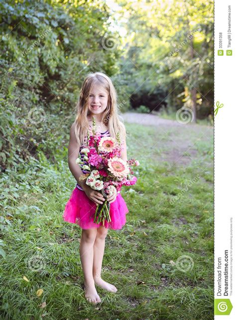 Protruding off the bow were three sets of metal turning the magic wand into silk scarves and pulling out a bunch of flowers from a hollow pipe that enclosed a lit candle were some of his acts that won. Cute Girl Holding A Bunch Of Flowers Royalty Free Stock ...