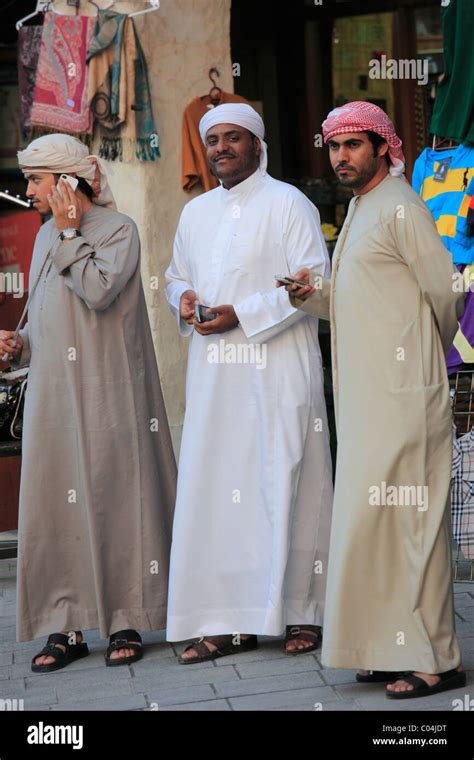 Qatar Doha Young Men Traditional Dress Mobile Phones Stock Photo