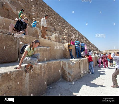 Tourists Climbing On The Great Pyramid Of Giza Stock Photo Alamy