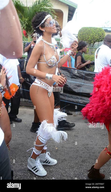 rihanna nearly bares it all in an extremely skimpy jeweled bikini as she attends the kadooment