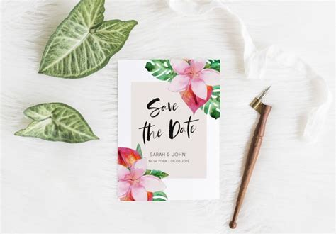 Save The Date Card With Pink Flowers And Green Leaves Next To It On A