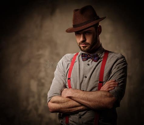 Serious Old Fashioned Man With Hat Wearing Suspenders And Bow Tie