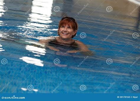Happy Mature Woman In Swimming Pool Stock Image
