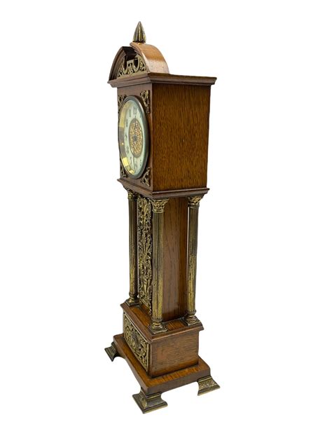 Ds An Edwardian Oak Miniature Longcase Clock With A Broken Pediment And Central Brass Finial