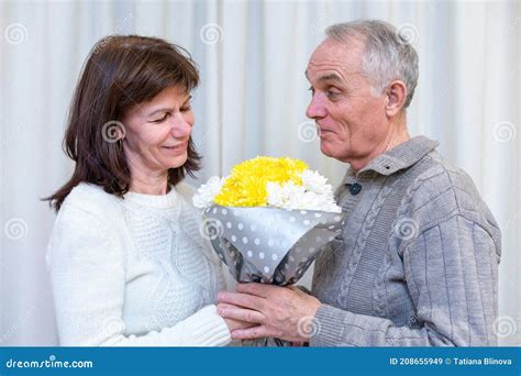 happy couple seniors celebrate valentine s day man gives woman a favorite bouquet of flowers