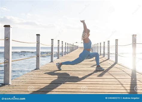 Woman Doing Yoga Exercises By The Sea Stock Photo Image Of Years Exercising