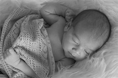 Grayscale Photography Baby Sleeping White Fur Comforter Boy