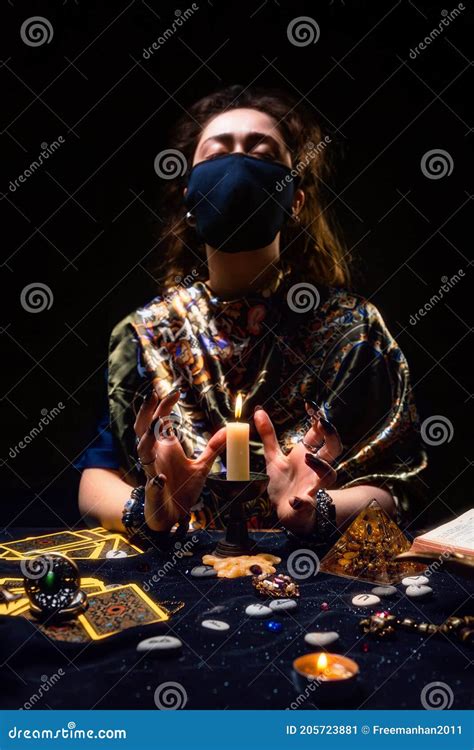 Divination And Astrology A Fortune Teller In A Medical Black Mask Is