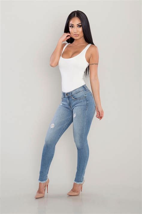 White Bodysuit Tucked Into Skinny Ripped Ankle Jeans Nude