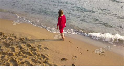 Top View Of A Woman Walking Barefoot Along Wet Sand Beach Running Wave
