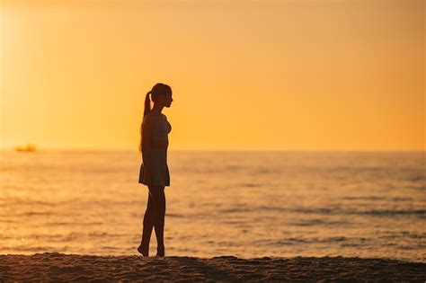 Premium Photo Silhouette Of The Beautiful Girl Enjoying Beautiful Sunset On The Beach