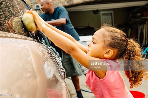 Father And Daughter Washing Car Photo Getty Images