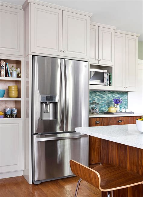 Most refrigerators stand around 70″ tall, slotting into a 6 foot space in the kitchen. White Kitchen Cabinets Over Refrigerator 2021 ...